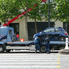 A tow truck in action on the streets of Paris.